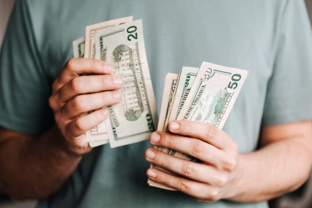 Man counting dollar banknotes